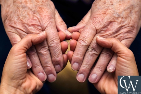 Elderly and Young Holding Hands